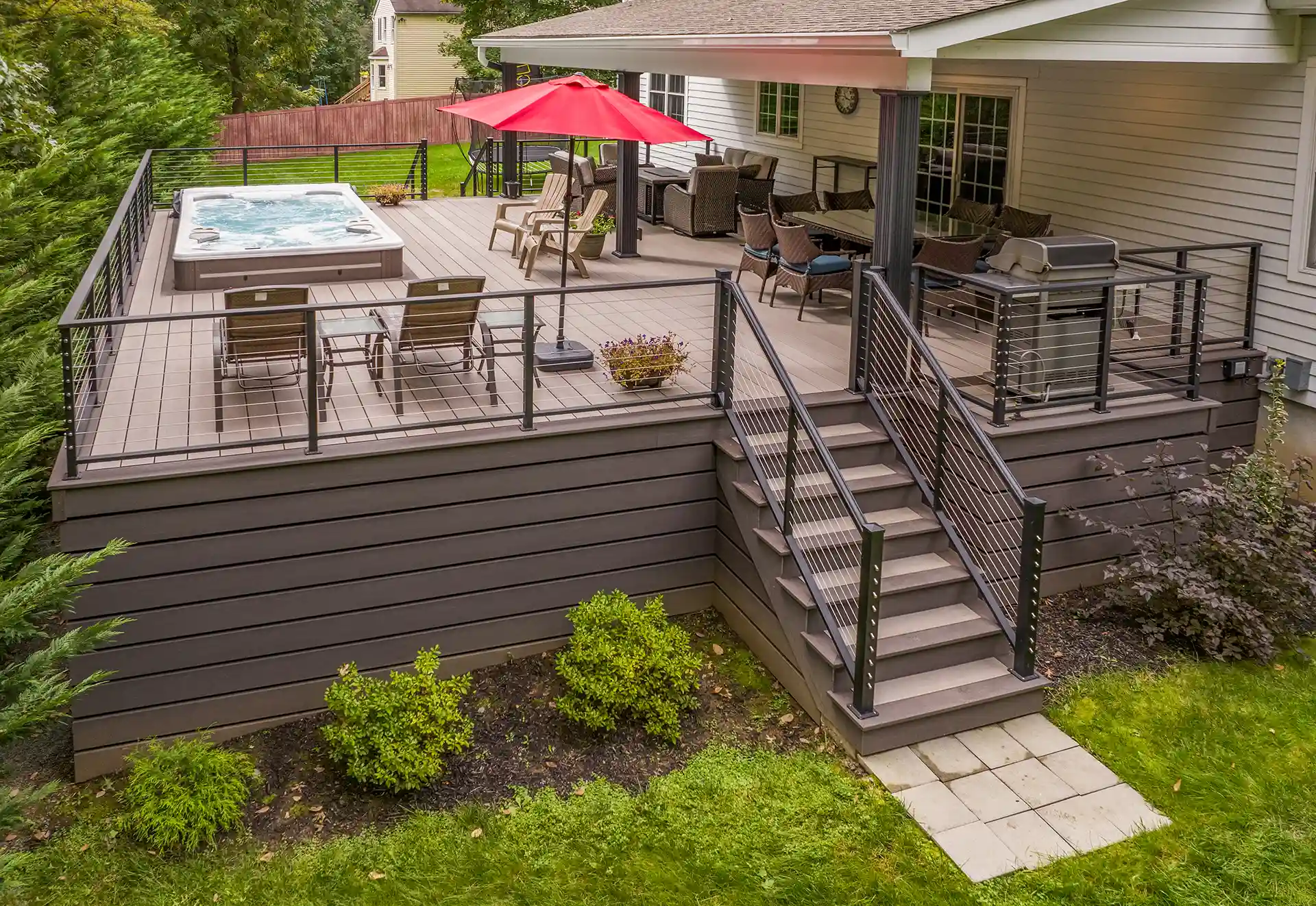 Photo of a raised deck with cable railing and outdoor furniture