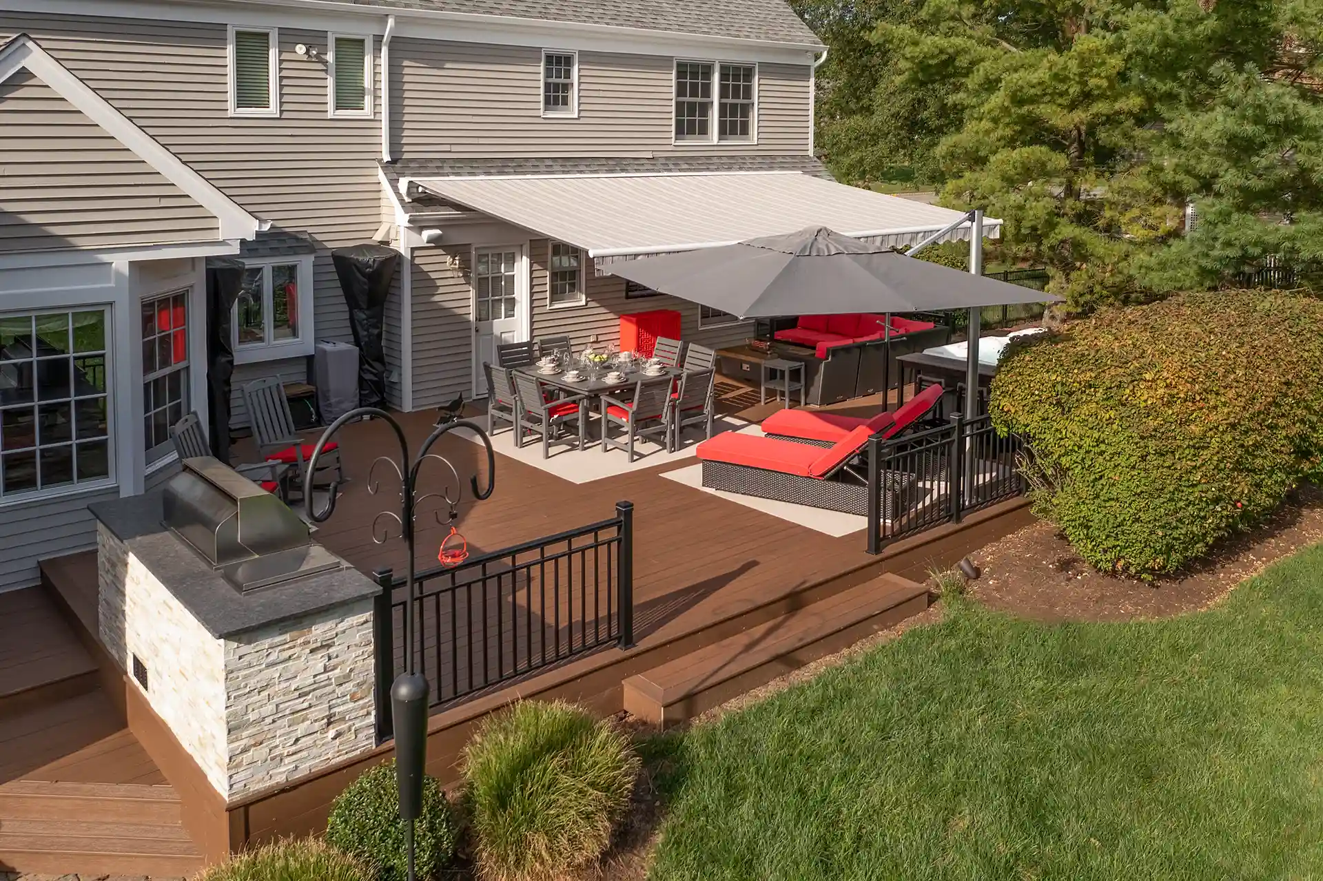 Photo of Large deck featuring awning with clean lines and modern fabric, offering wide shade coverage for family gatherings.
