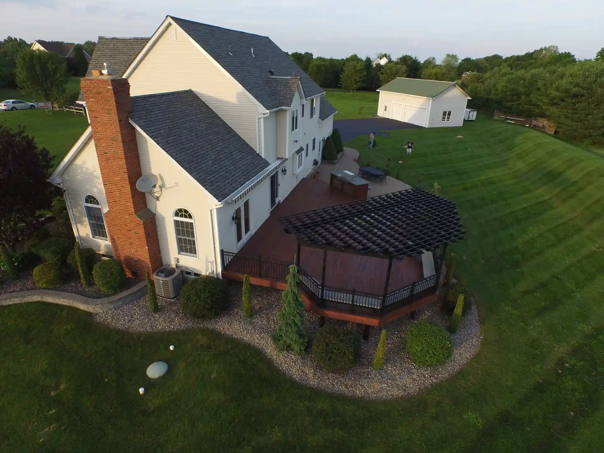 Aerial view of wood deck with pergola, outdoor kitchen, and outdoor furniture. 