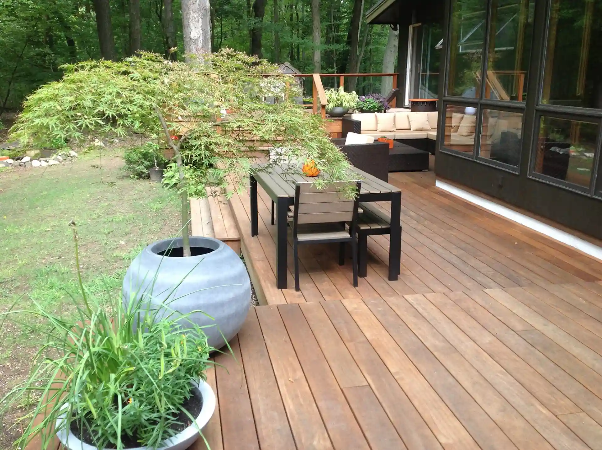Photo of a multi-level wood deck with distinct zones for different activities 