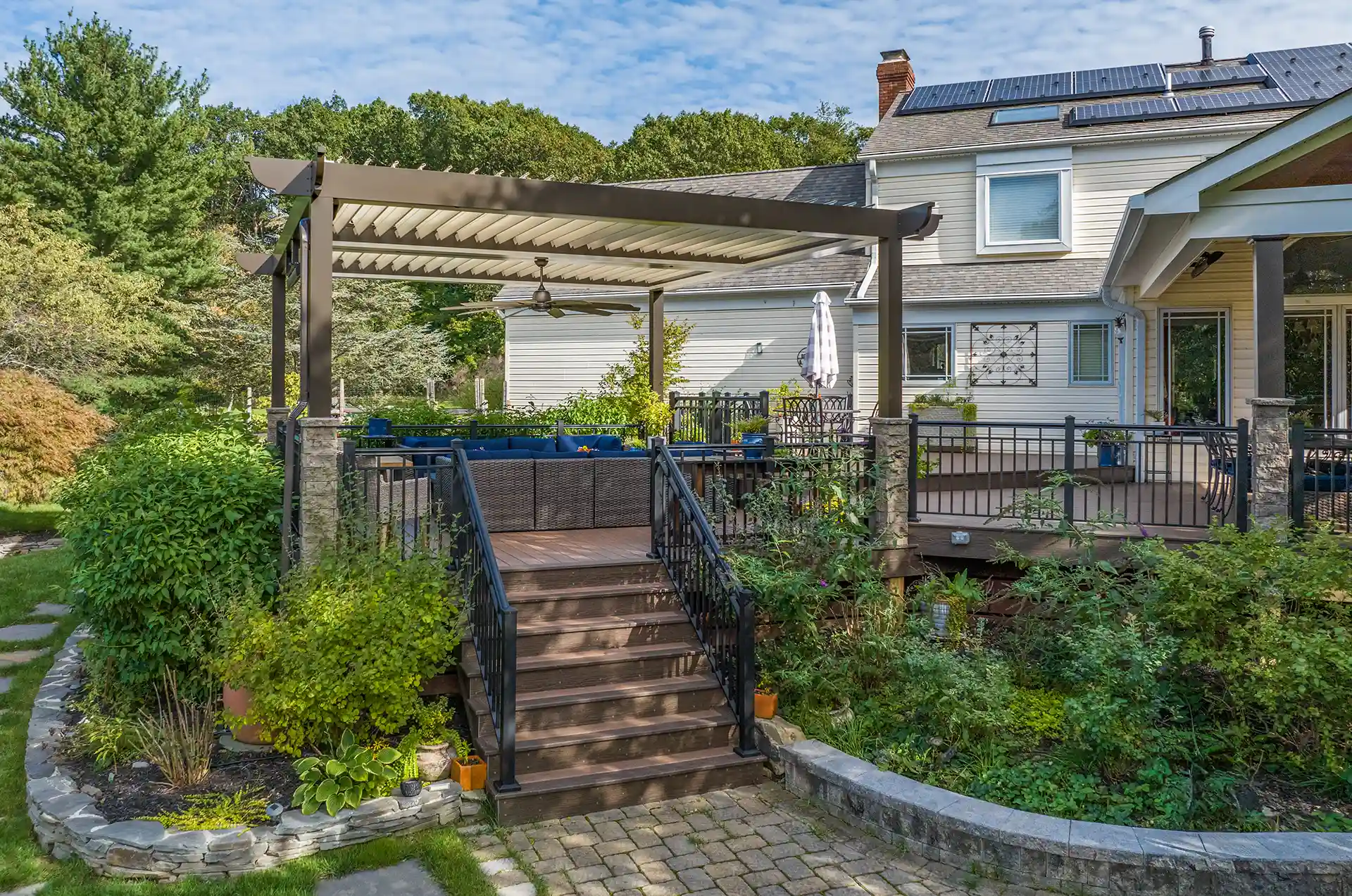 Photo of a multi-level deck with a covered deck area, an open area, and a pergola area.