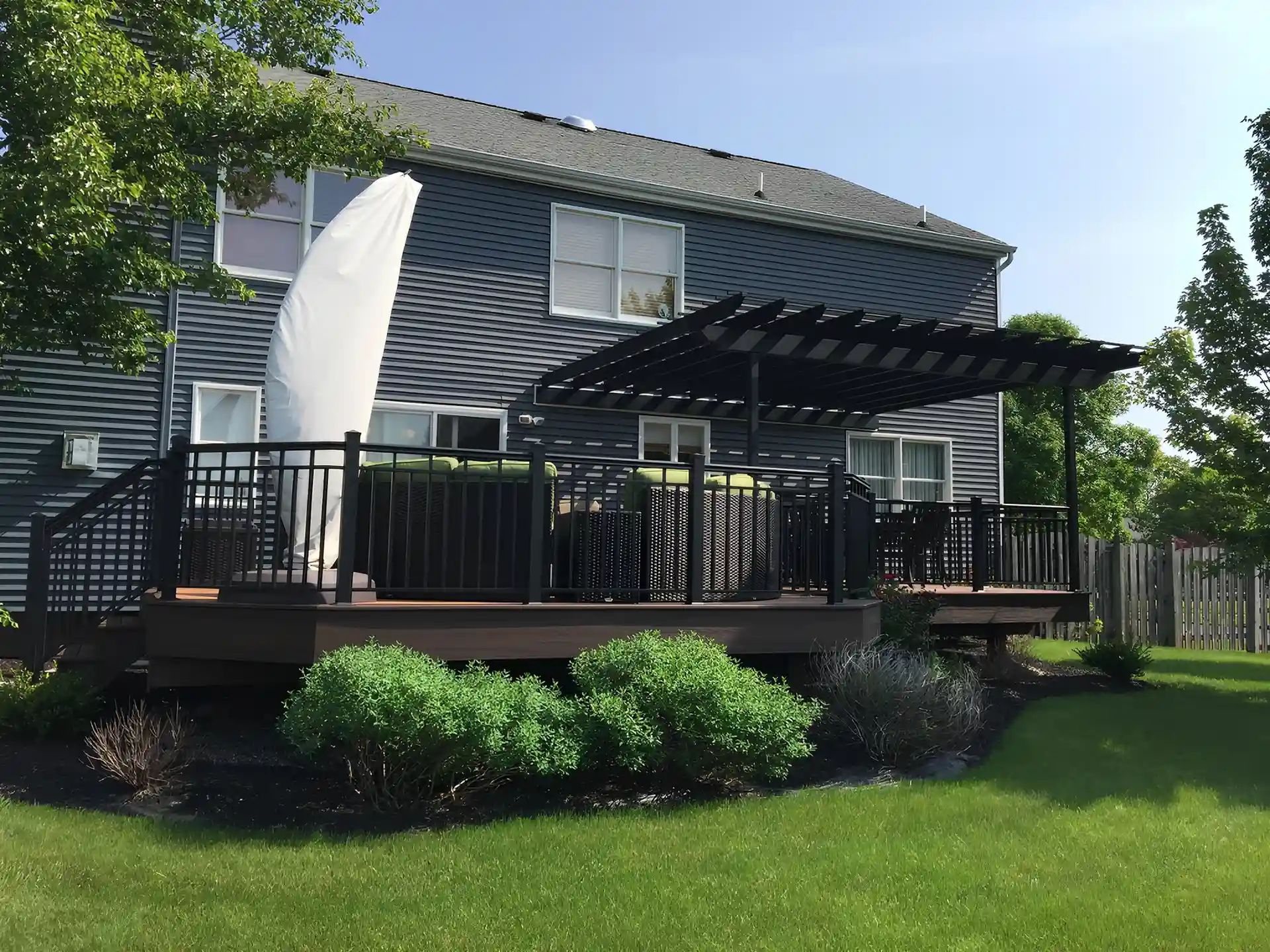 Photo of a raised deck with a traditional-style pergola