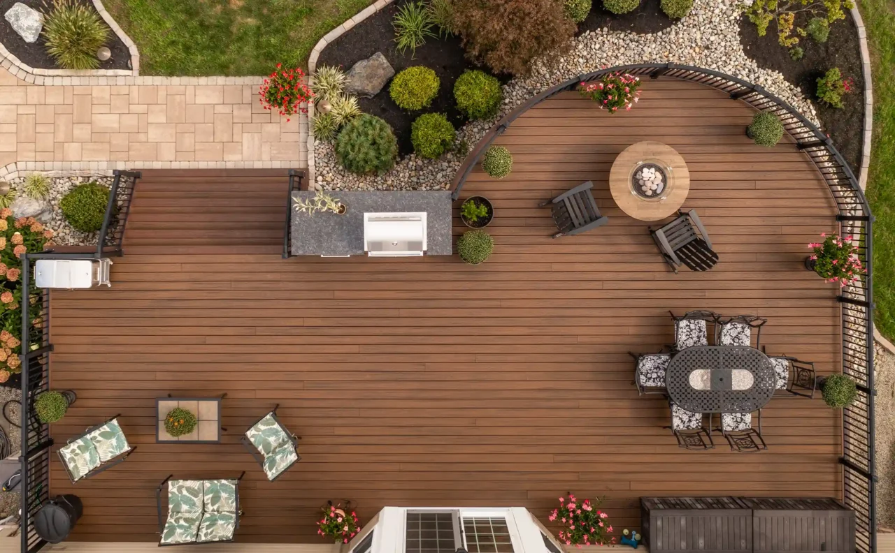 Aerial view of curved deck with deck railing and patio walkway.